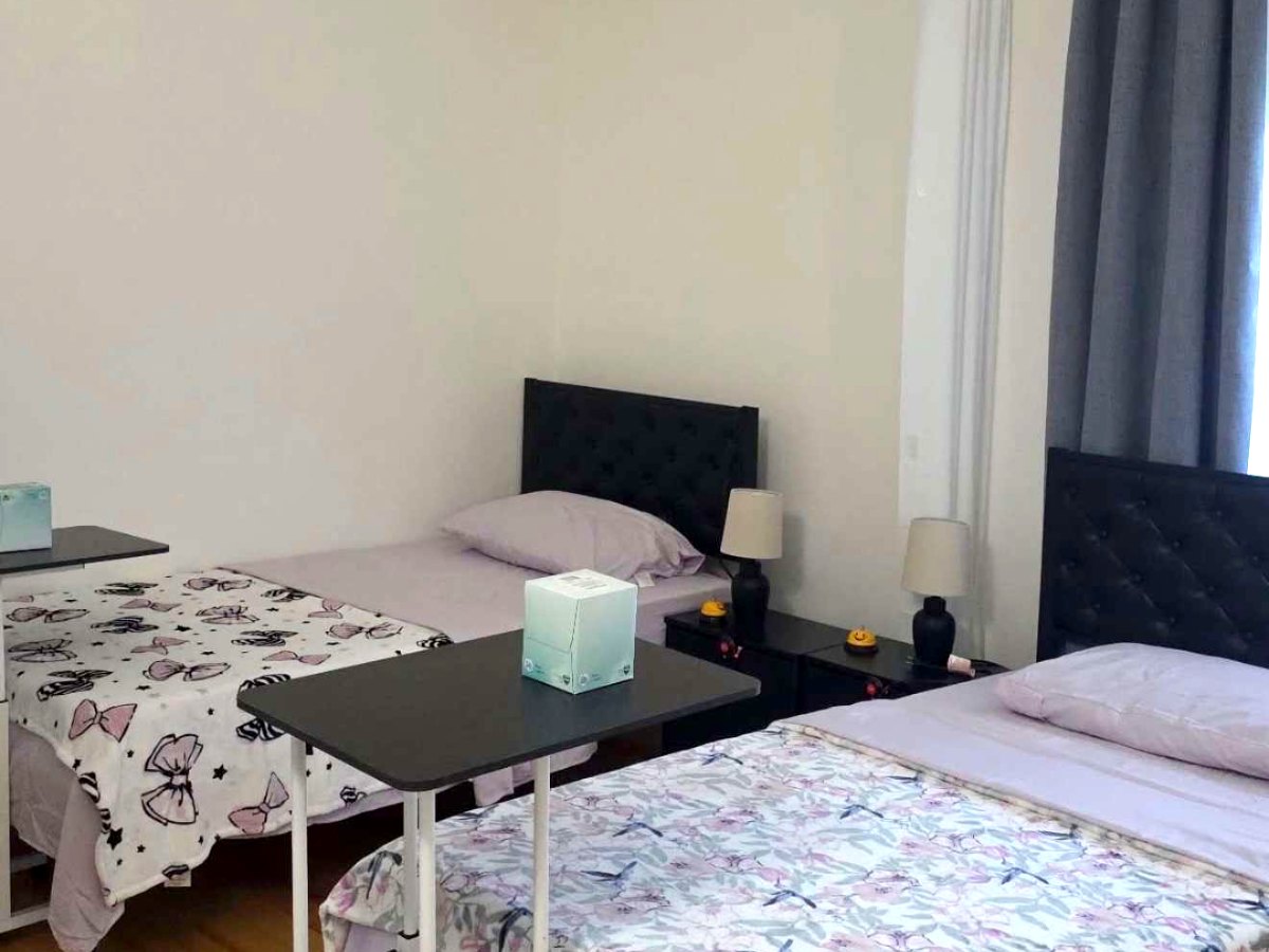 A resident bedroom at Blessed Home Senior Care, with two neatly made beds